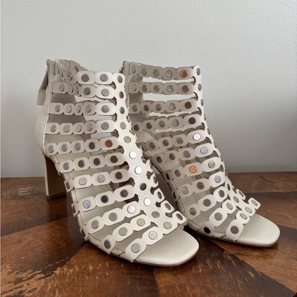 Size 9 3.5in heel. brand is 1.State. white and silver strapy heel
